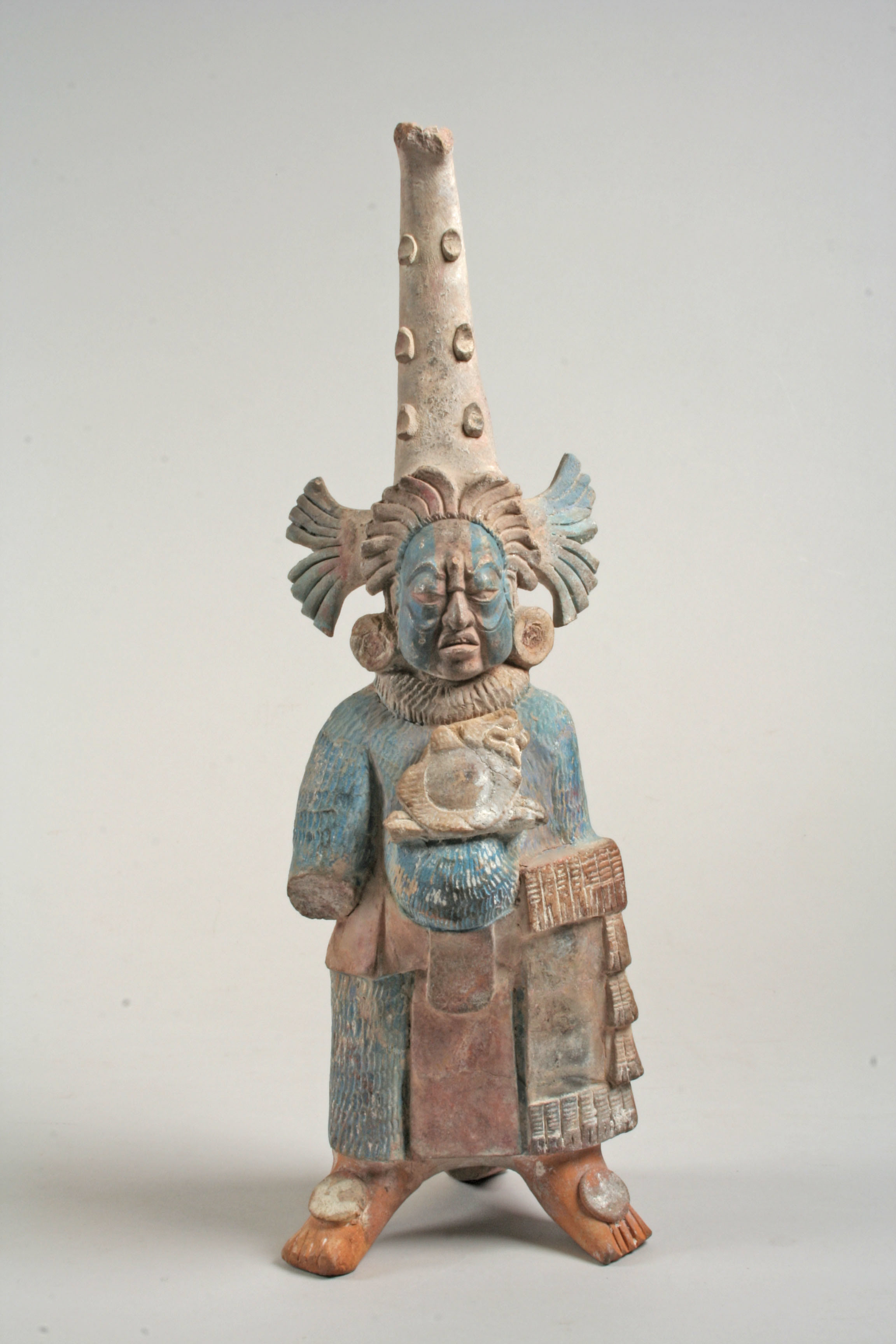 Figure with conical headdress and shield